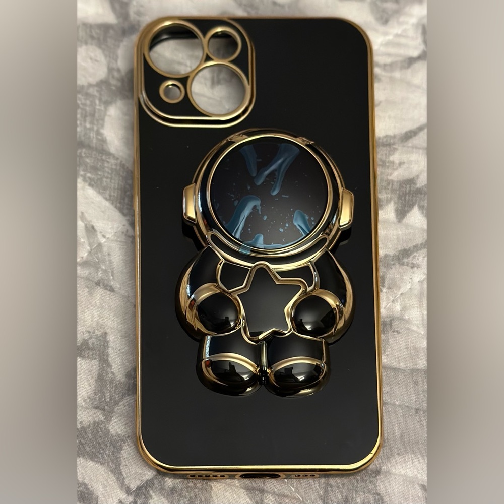Black and gold astronaut iPhone 14 case. New with plastic still on.